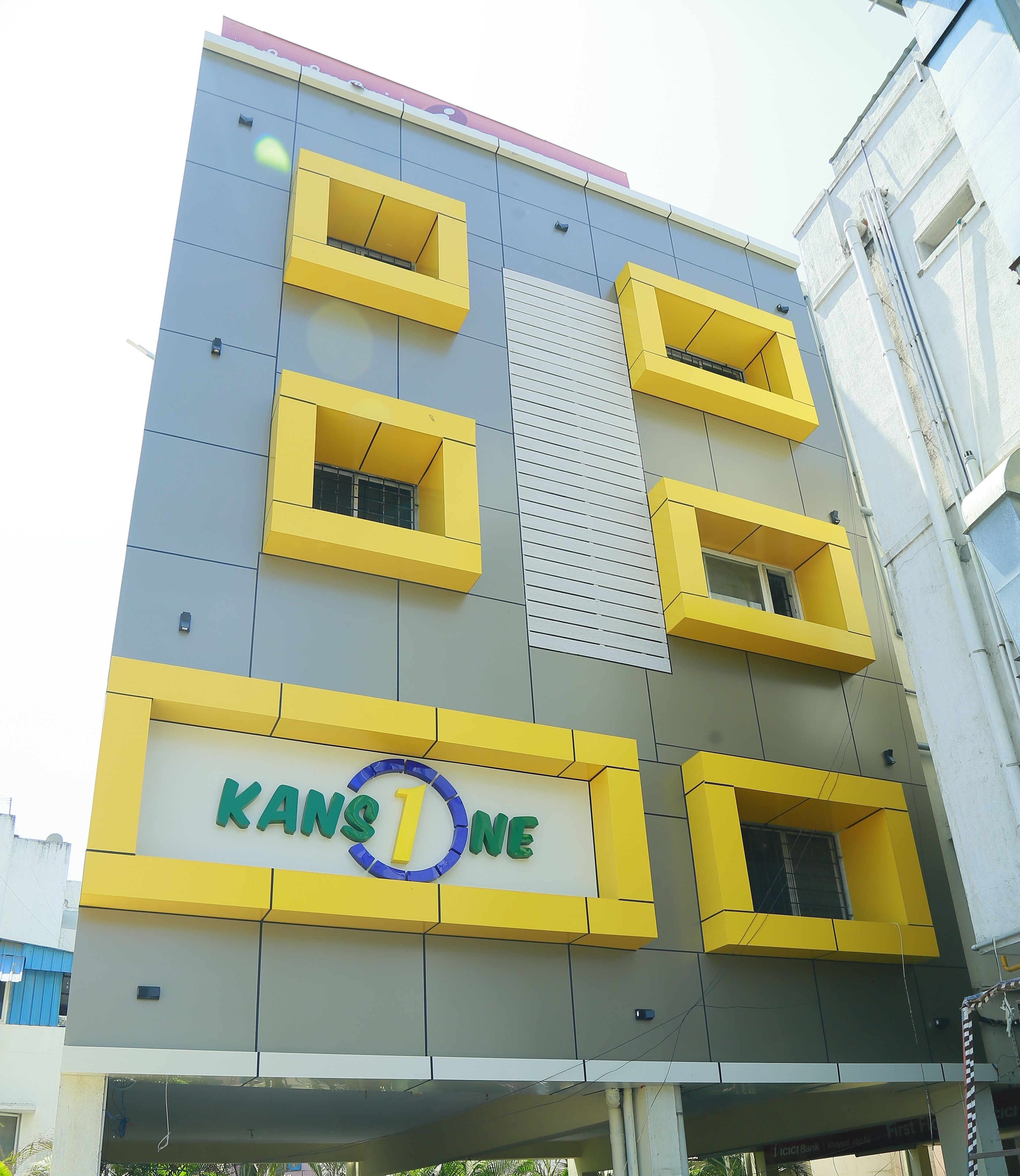 A multi-story building with a prominent sign reading "KANSONE" on the lower facade.