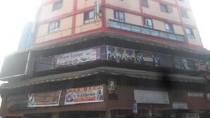 A multi-story building with various commercial establishments on the ground floor, including a bar and restaurant named "Miami Lounge." - Magi Guest House (Thika)