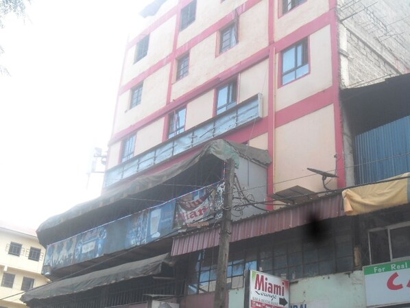 A multi-story building with a sign for 'Miami Lounge' on the ground floor.