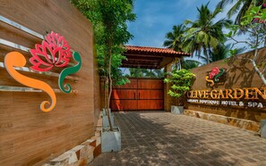 A wooden gate with a sign for Clive Garden Luxury Boutique Hotel & Spa.