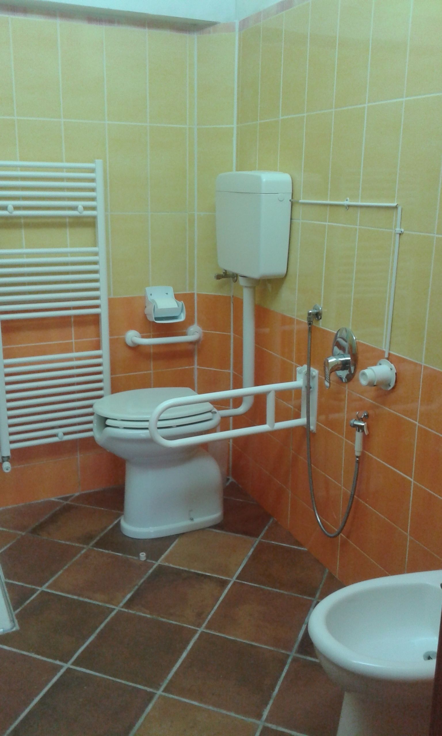 A bathroom with a toilet, bidet, and sink.