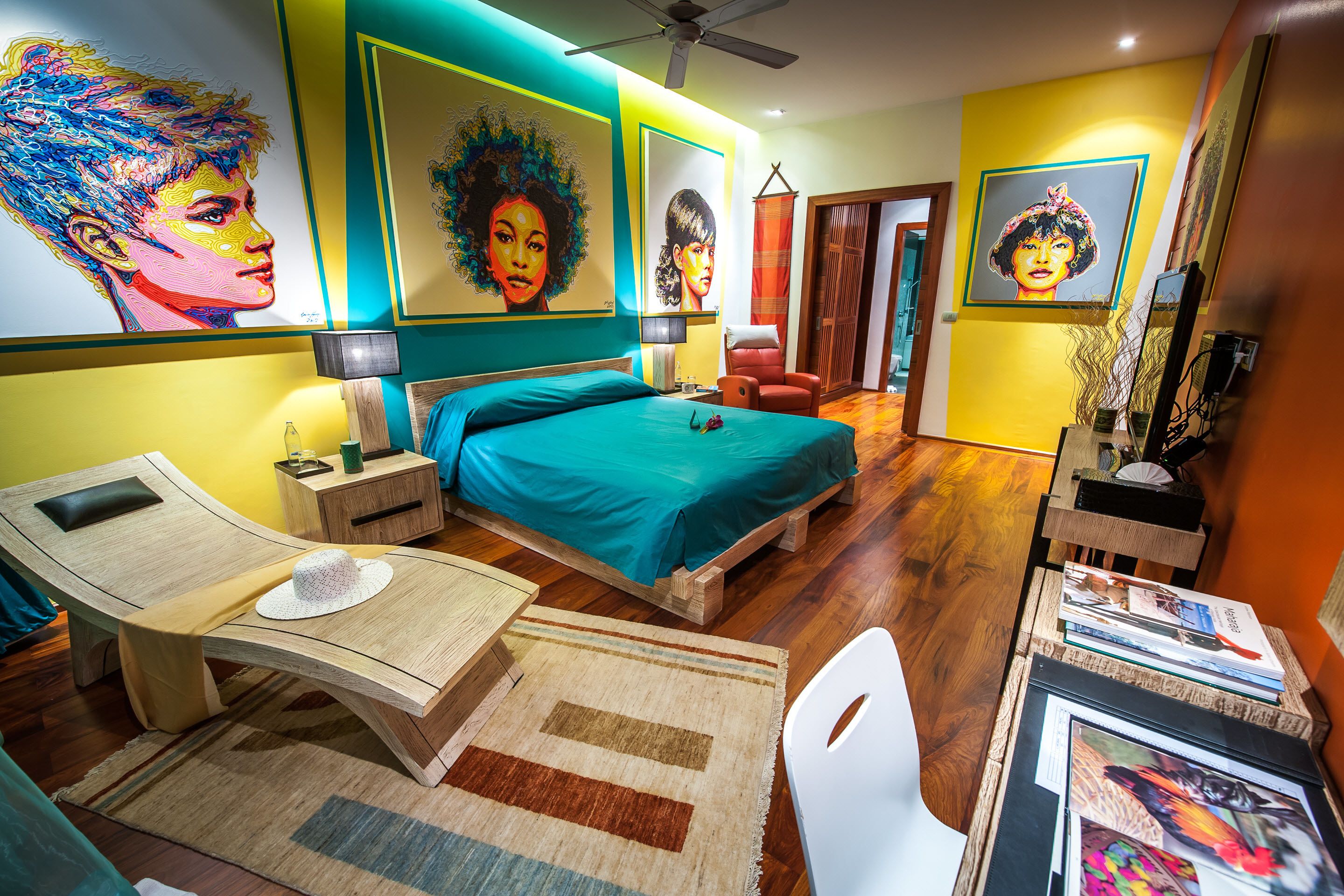 A modern bedroom with a bed, bedside tables, a desk, and a chair.