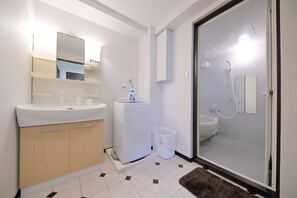 Deluxe appartement | Badkamer | Een aparte badkuip en douche, gratis toiletartikelen, een haardroger