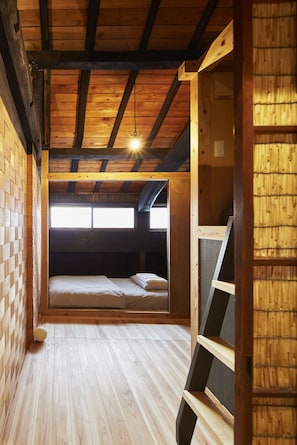 Un intérieur en bois avec un lit en mezzanine et une échelle.