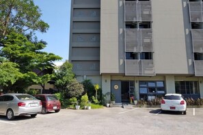 A multi-story building with a parking lot in front. - The51Hometel (Chiangmai)