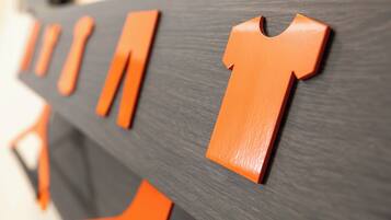 A close-up of a wooden structure with orange shapes resembling letters.
