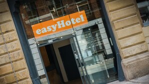 A hotel entrance with a glass door and an orange sign reading "easyHotel". - easyHotel Manchester (Manchester)