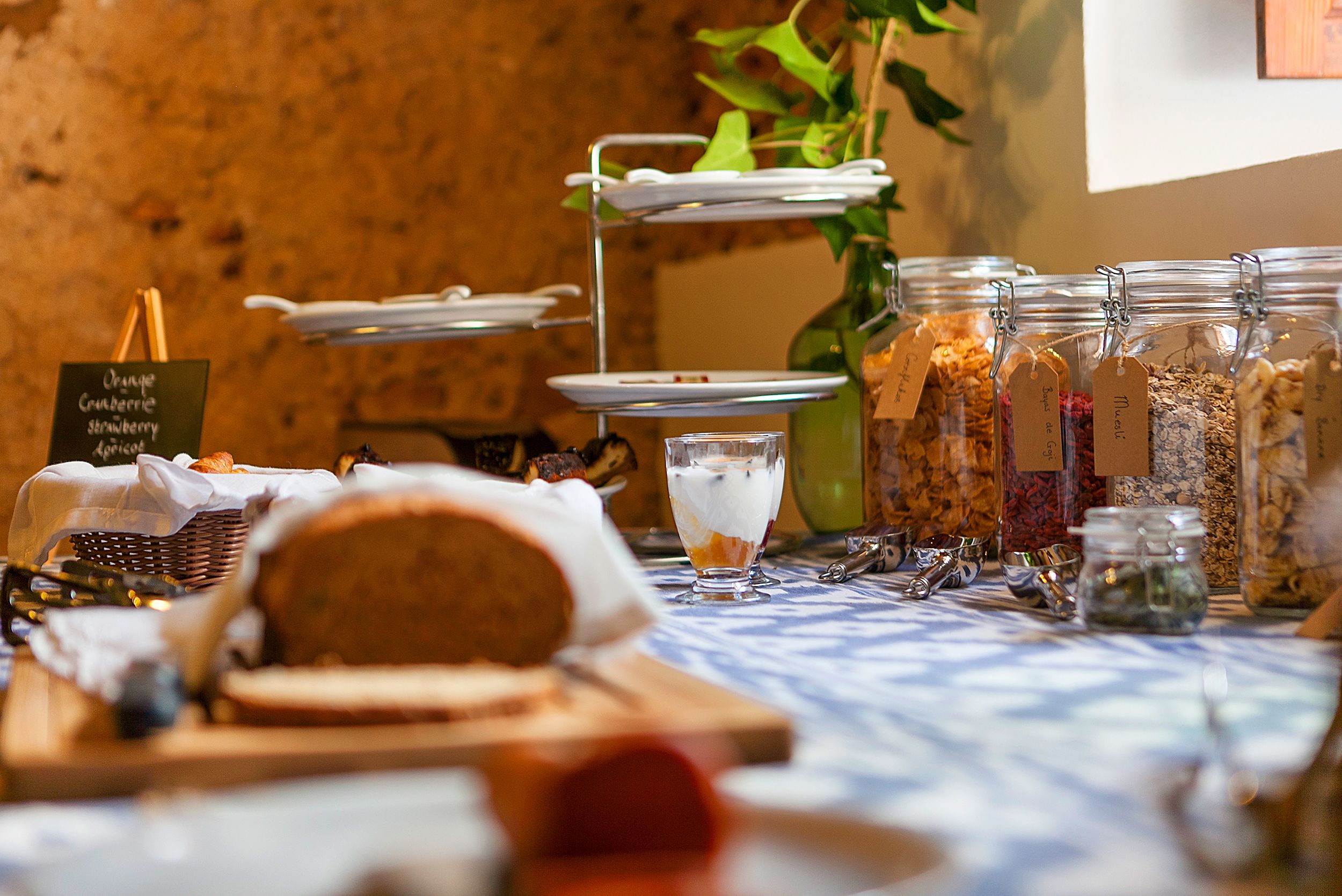 A buffet setup with various food items and condiments.