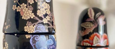 Two black nesting dolls with intricate floral designs.