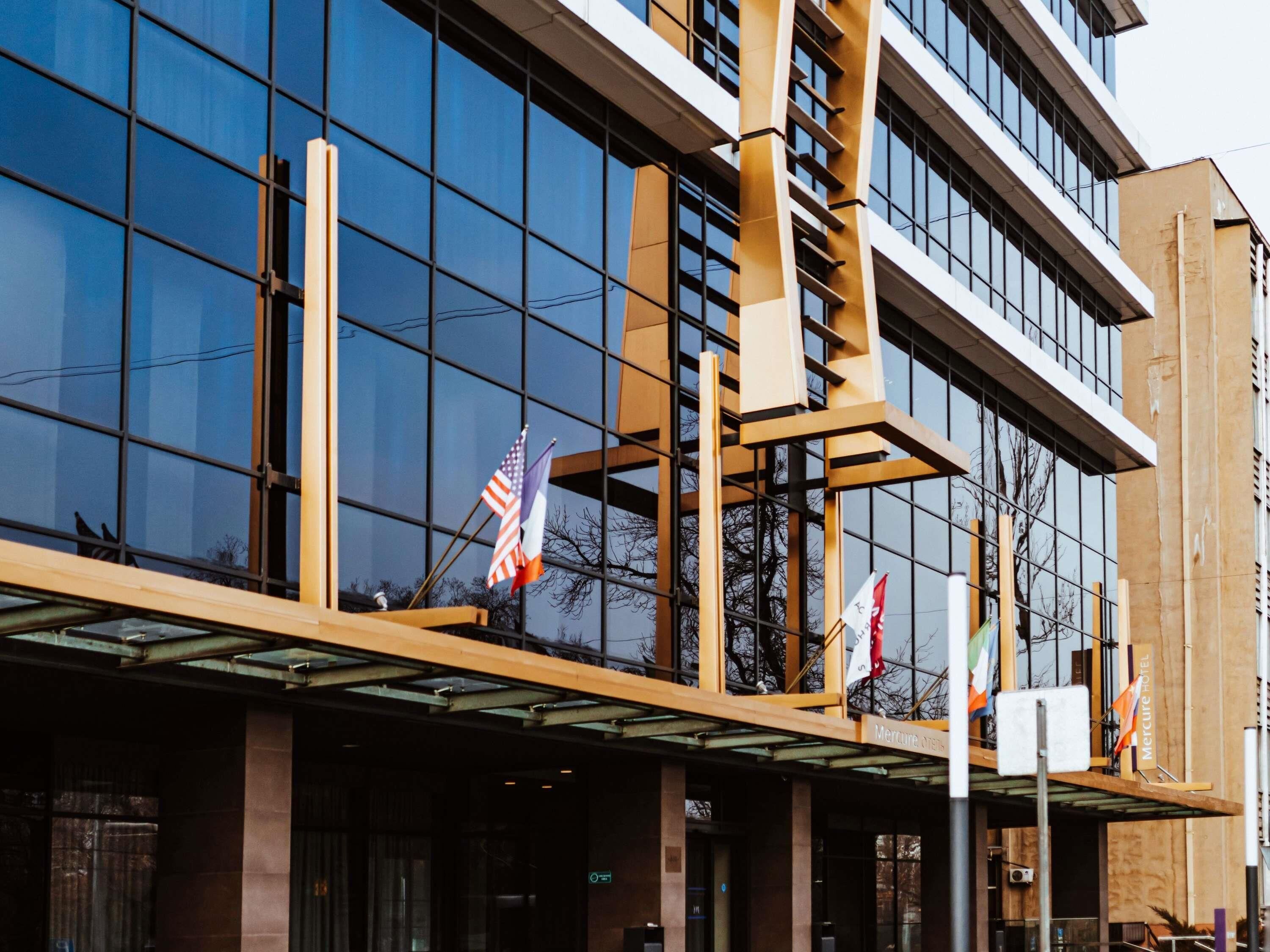 A modern building with large glass windows and a wooden facade.
