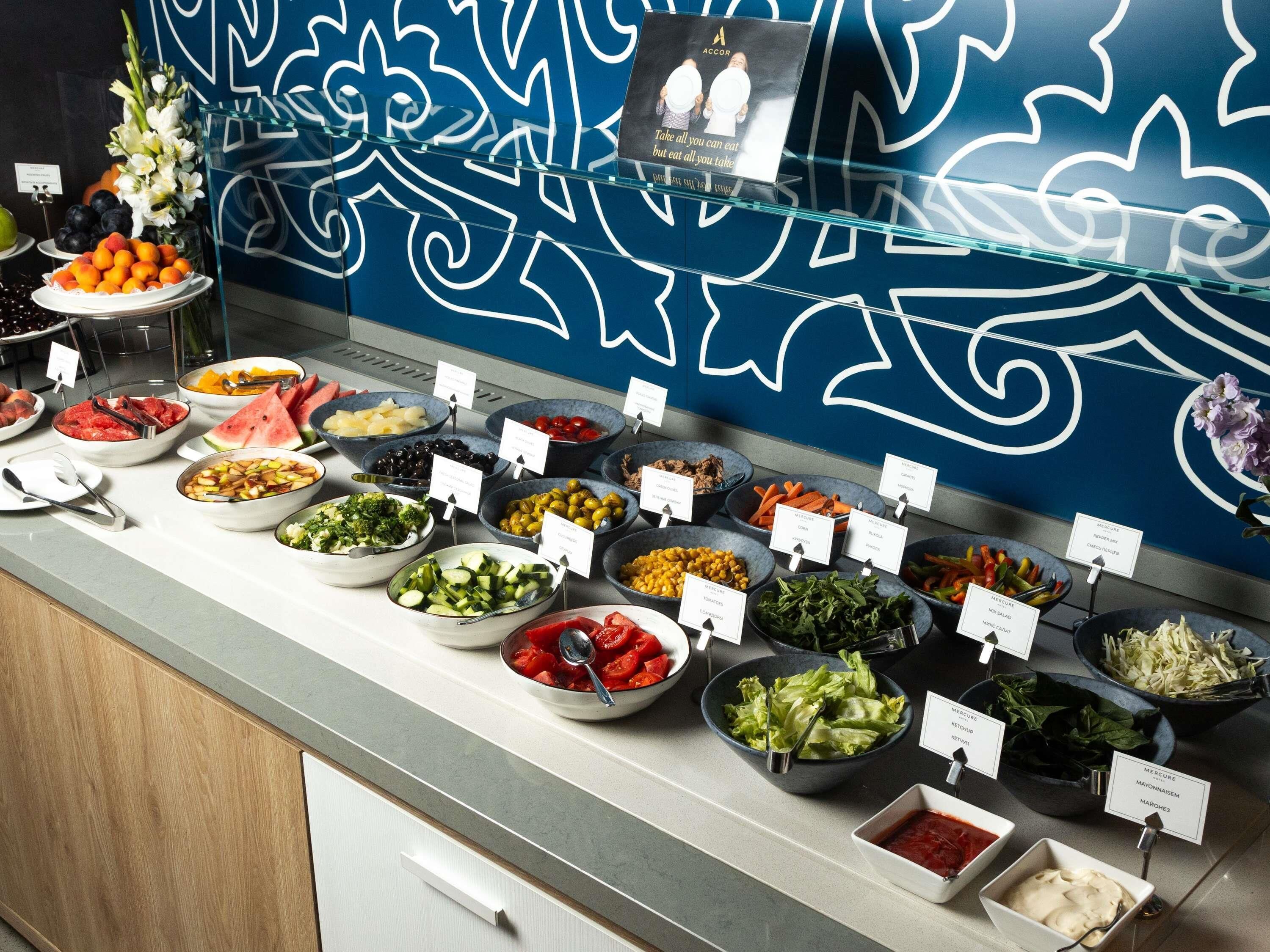 A buffet with various food options and labels.