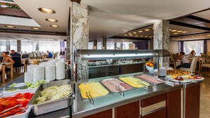A buffet area with various food options, marble columns, and a modern interior design. - Hotel Medena (Seget)