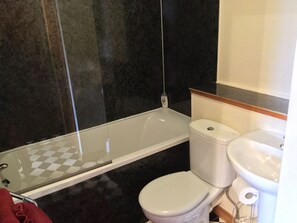 A bathroom with a glass-enclosed shower, a white toilet, and a sink. - One bedroom Wyvis (Inverness)