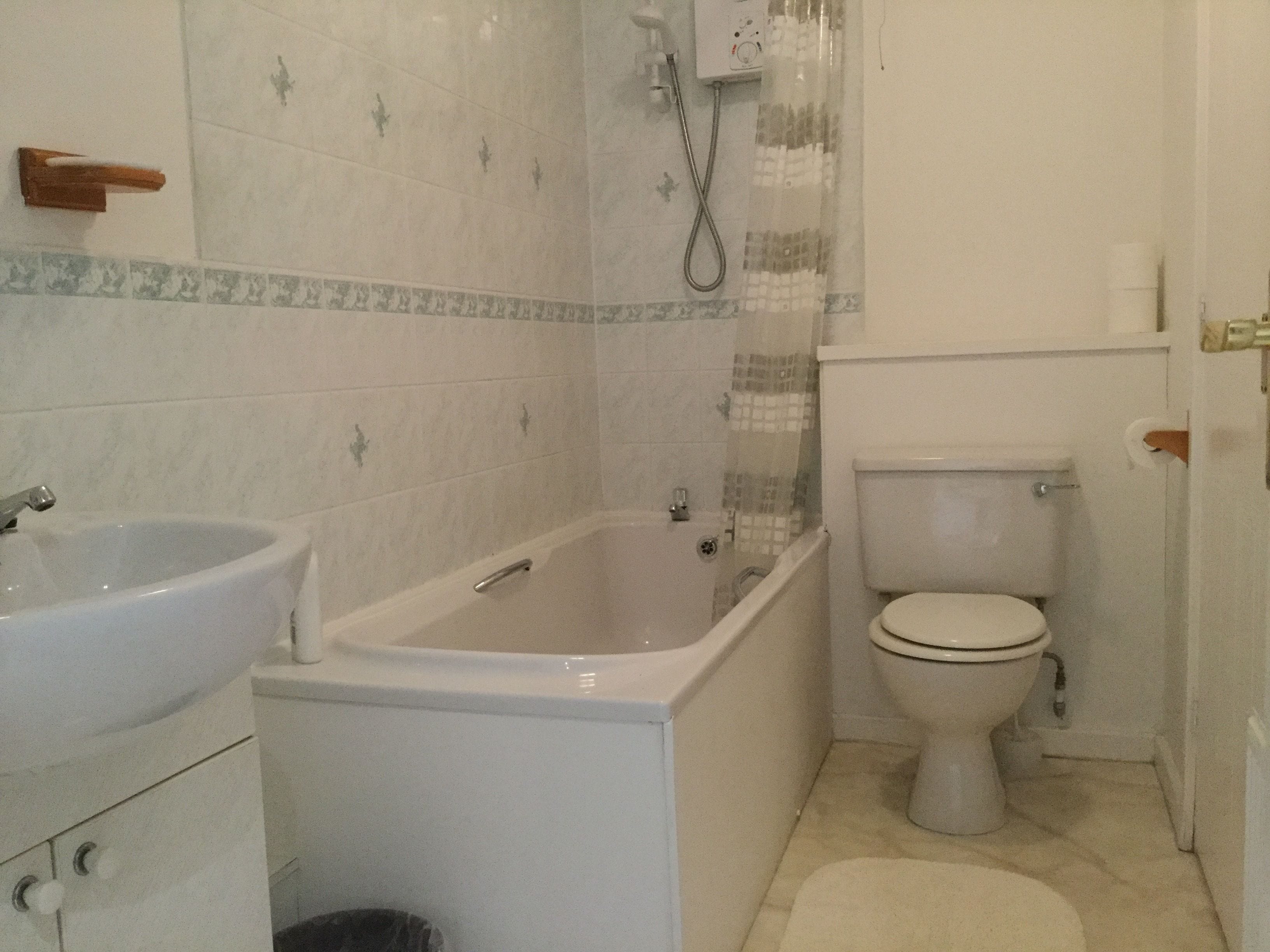 A bathroom with a bathtub, a sink, and a toilet.