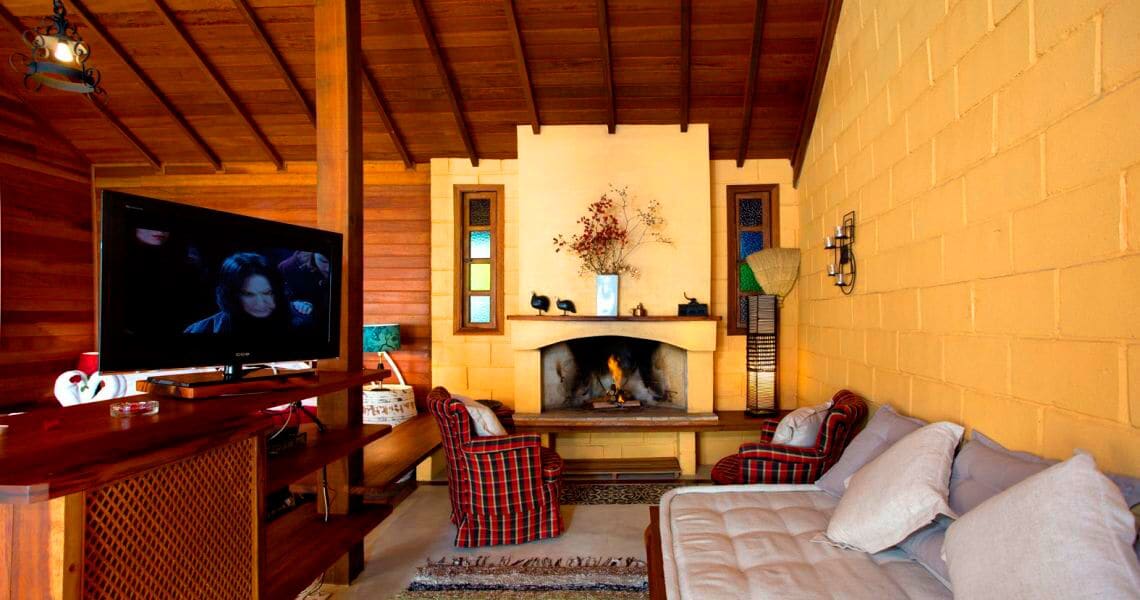 A cozy living room with a fireplace, a television, and a comfortable seating area.