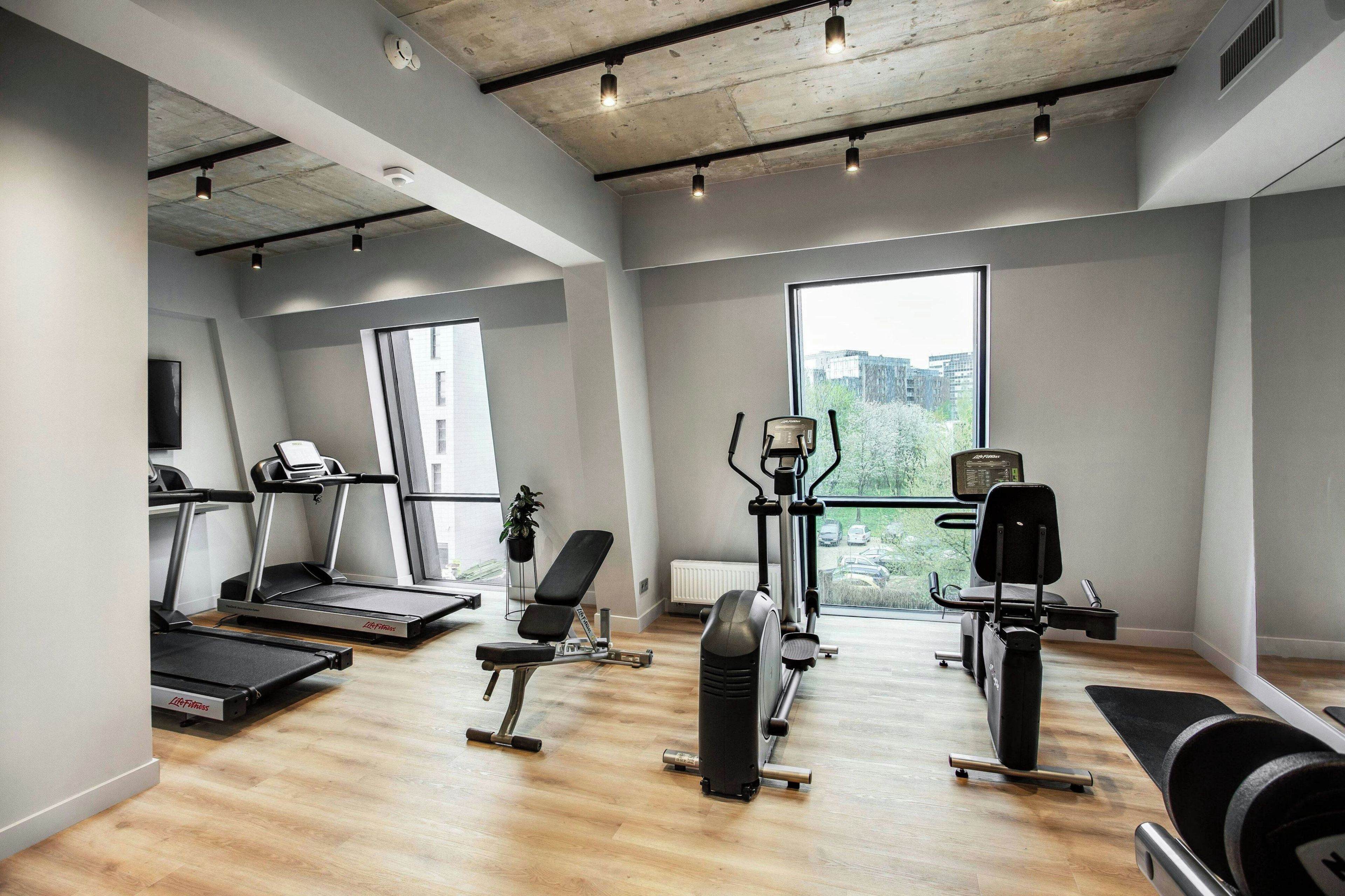 A gym with treadmills, a stationary bike, and weight machines.
