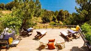 A wooden deck with lounge chairs and a pool labeled "DEEP BLUE." - Deep Ocean Camping - Adults Only (Fethiye)
