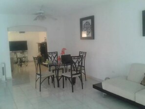 Relax in this inviting space with a sofa, dining table, and flat-screen TV.