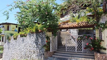 Stroll through lush gardens to this charming home, surrounded by vibrant flowers and a serene atmosphere.