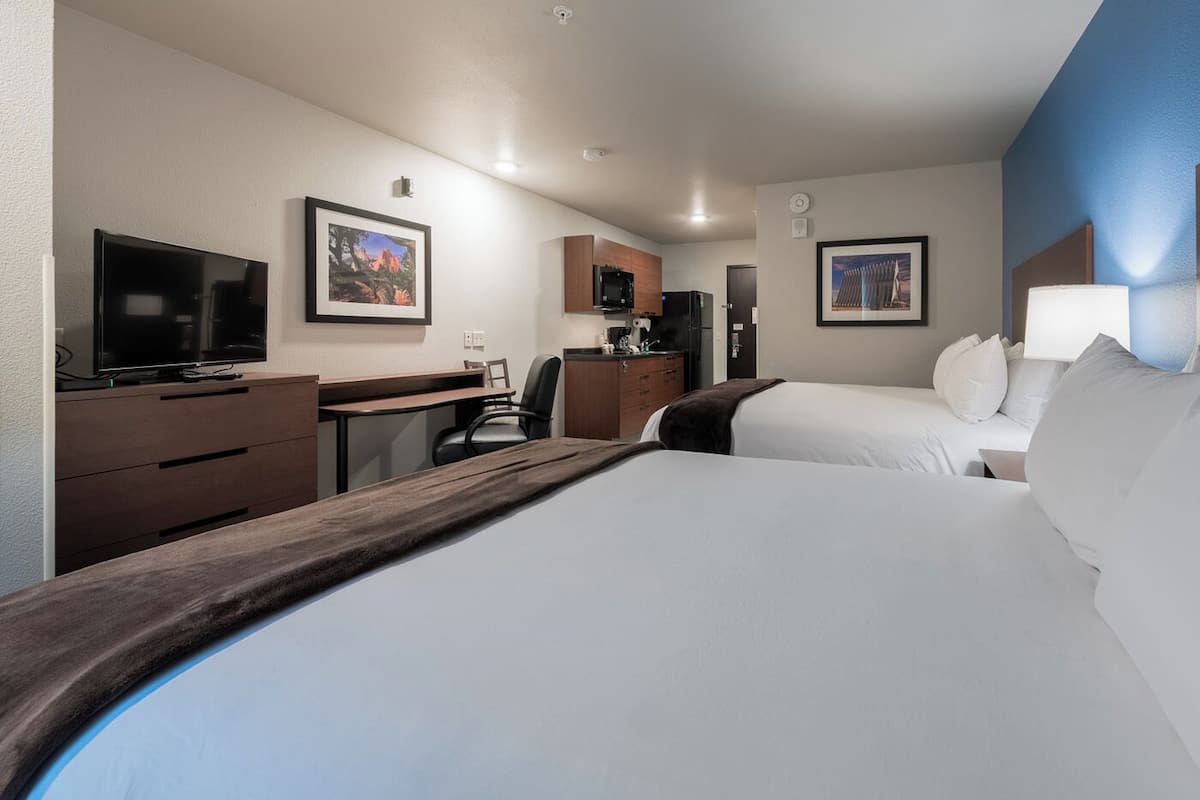 Premium bedding, pillow-top beds, desk, laptop workspace