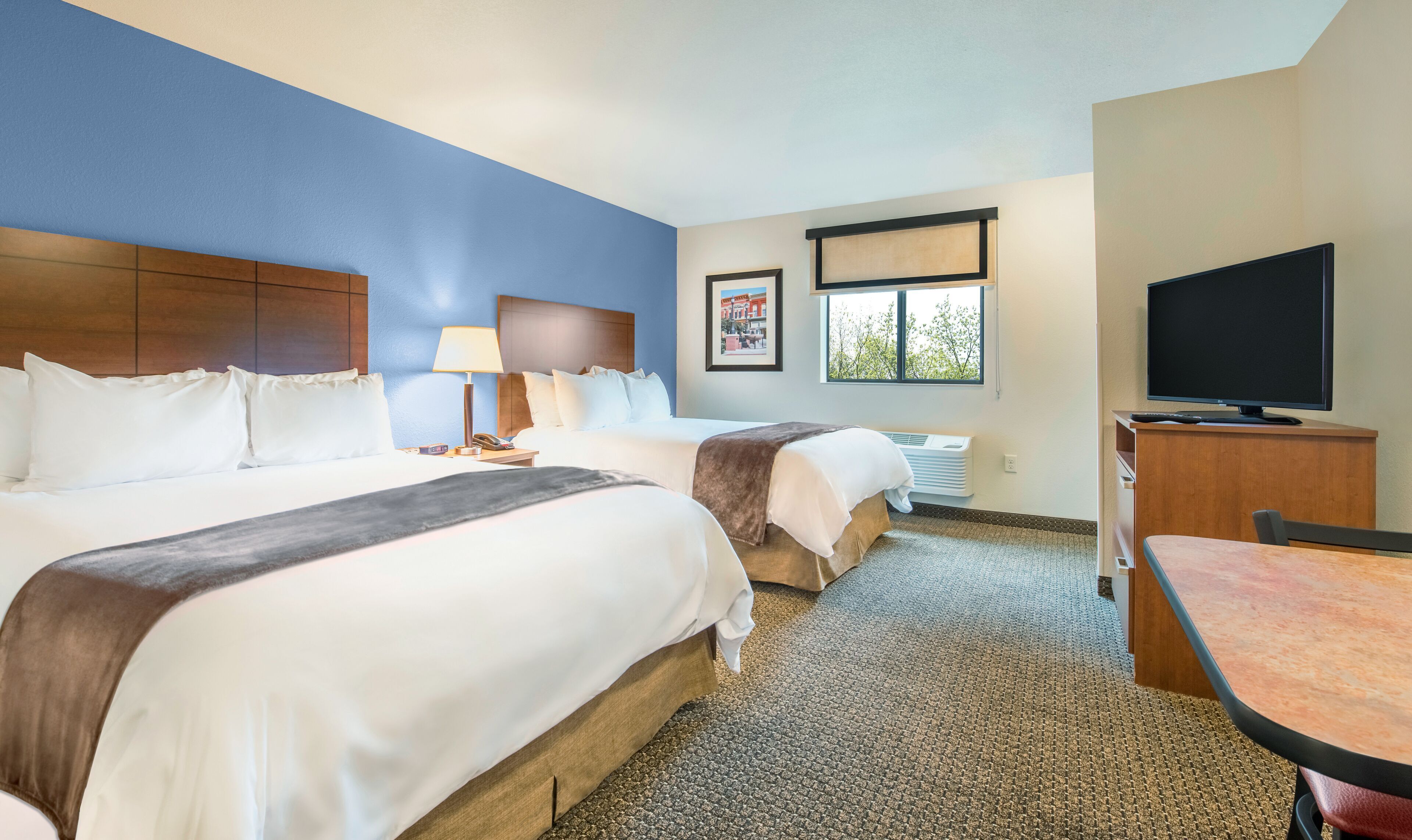 Premium bedding, pillow-top beds, desk, laptop workspace