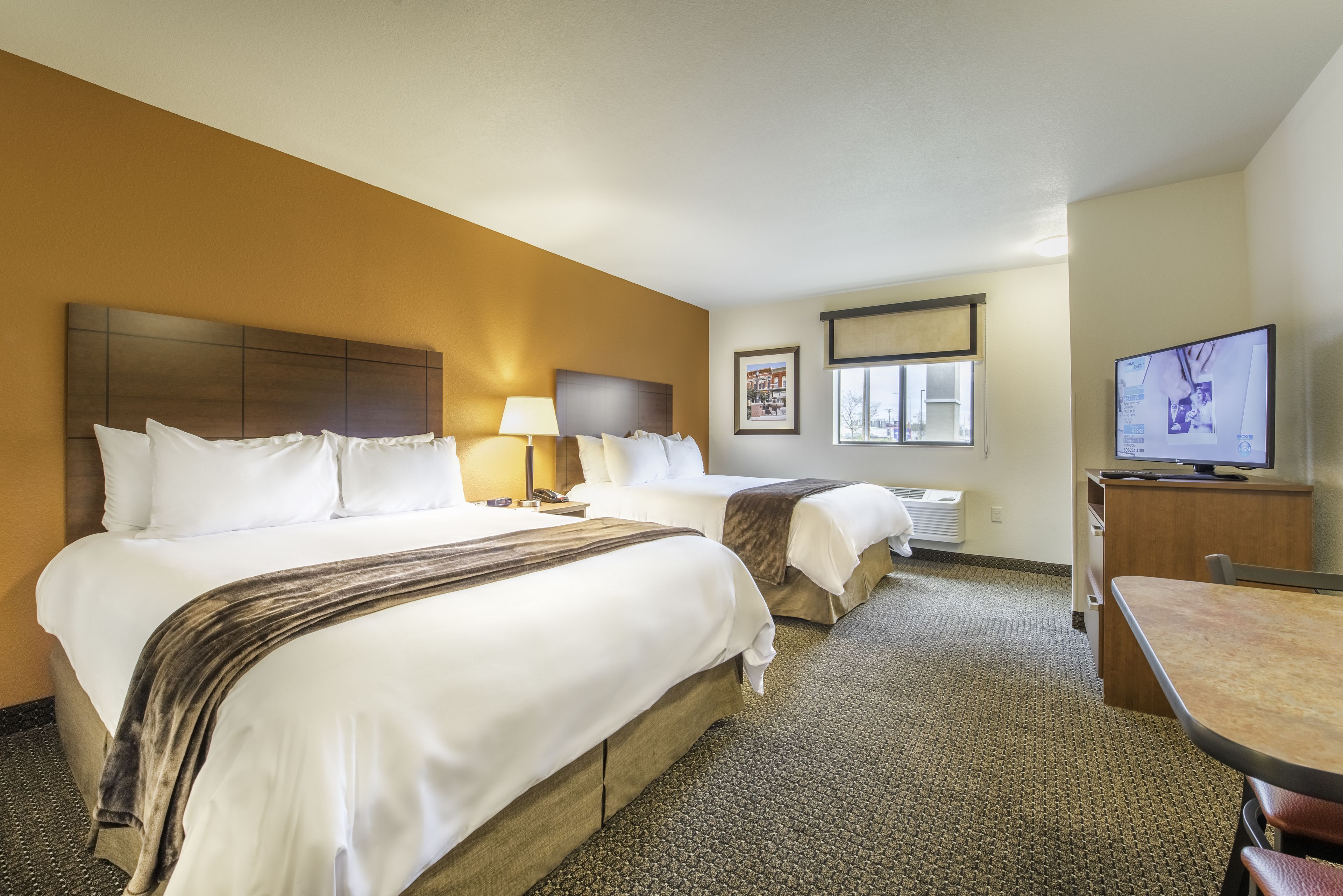 Premium bedding, pillow-top beds, desk, laptop workspace