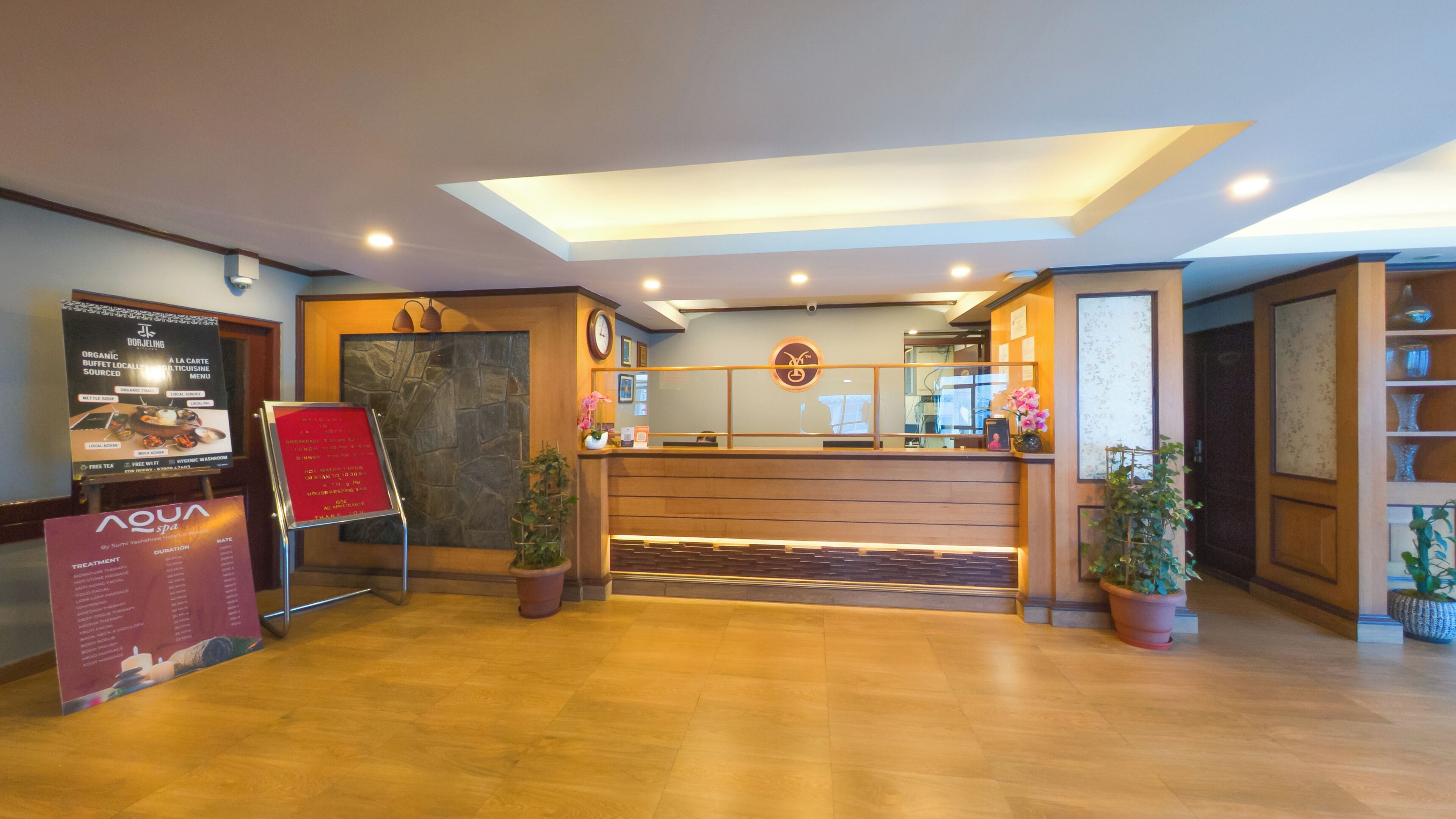 A reception area with a wooden reception desk, a clock, and a menu board.