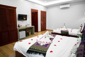 A hotel room with two beds, a small desk, a television, and a wardrobe. - Romantic Angkor Residence (Siem Reap)