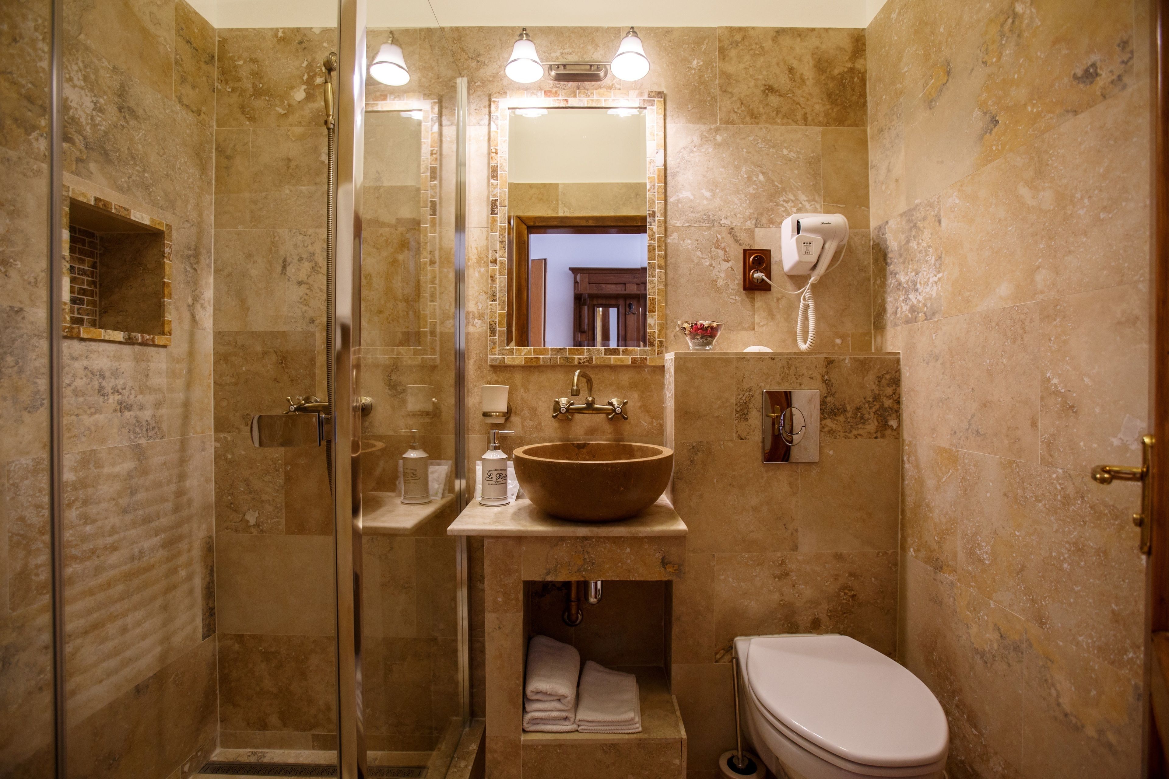 Une salle de bain avec une douche à parois de verre, un grand lavabo et des toilettes.