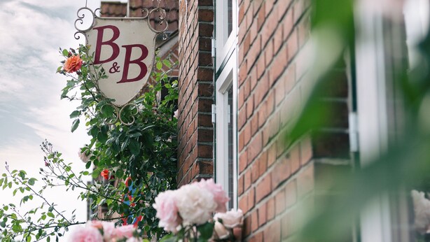 A building with a sign reading "BB" and a brick facade. - LOFTvorSYLT (Friedrichstadt)