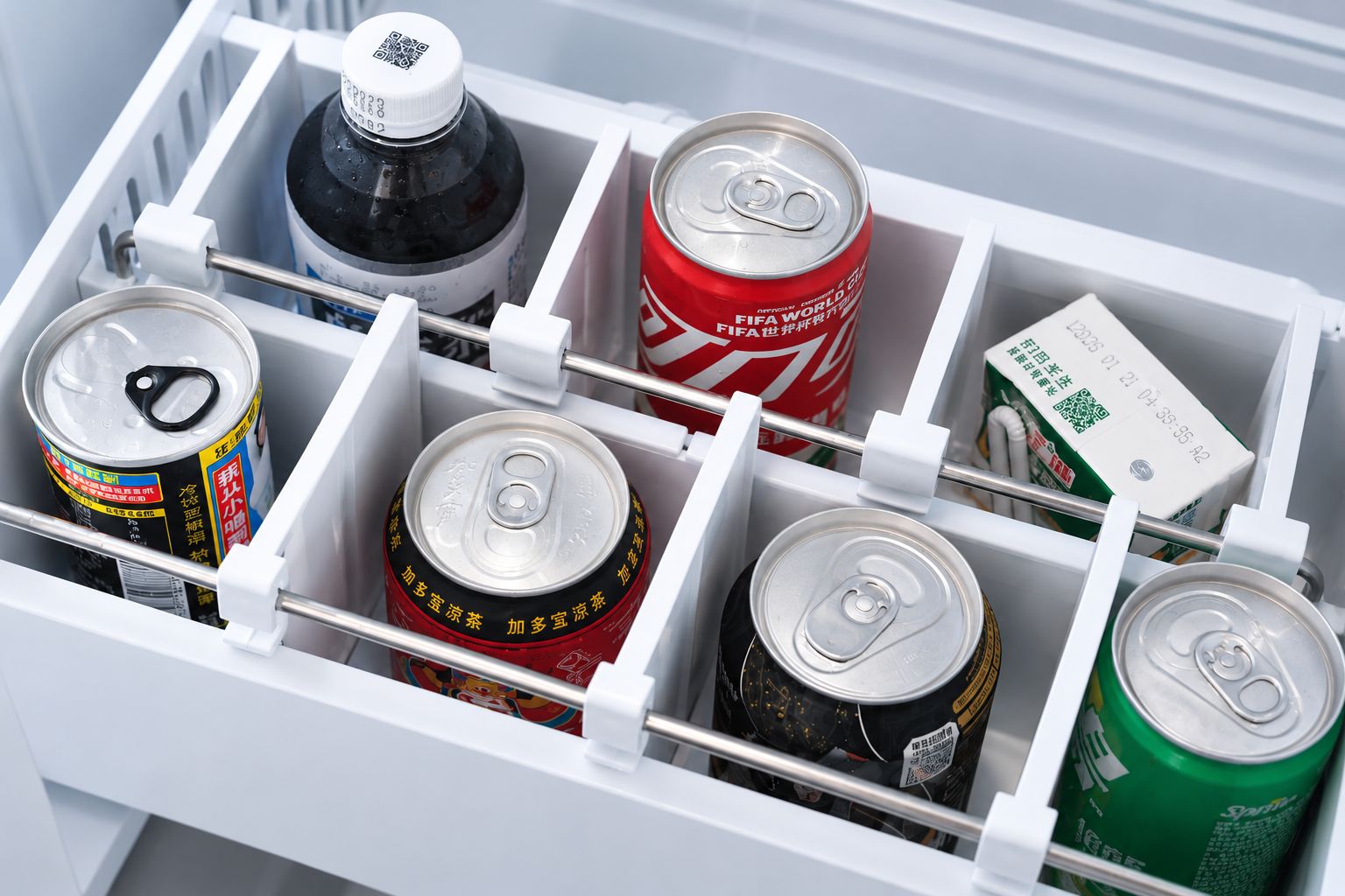 A refrigerator with multiple beverage cans and bottles.