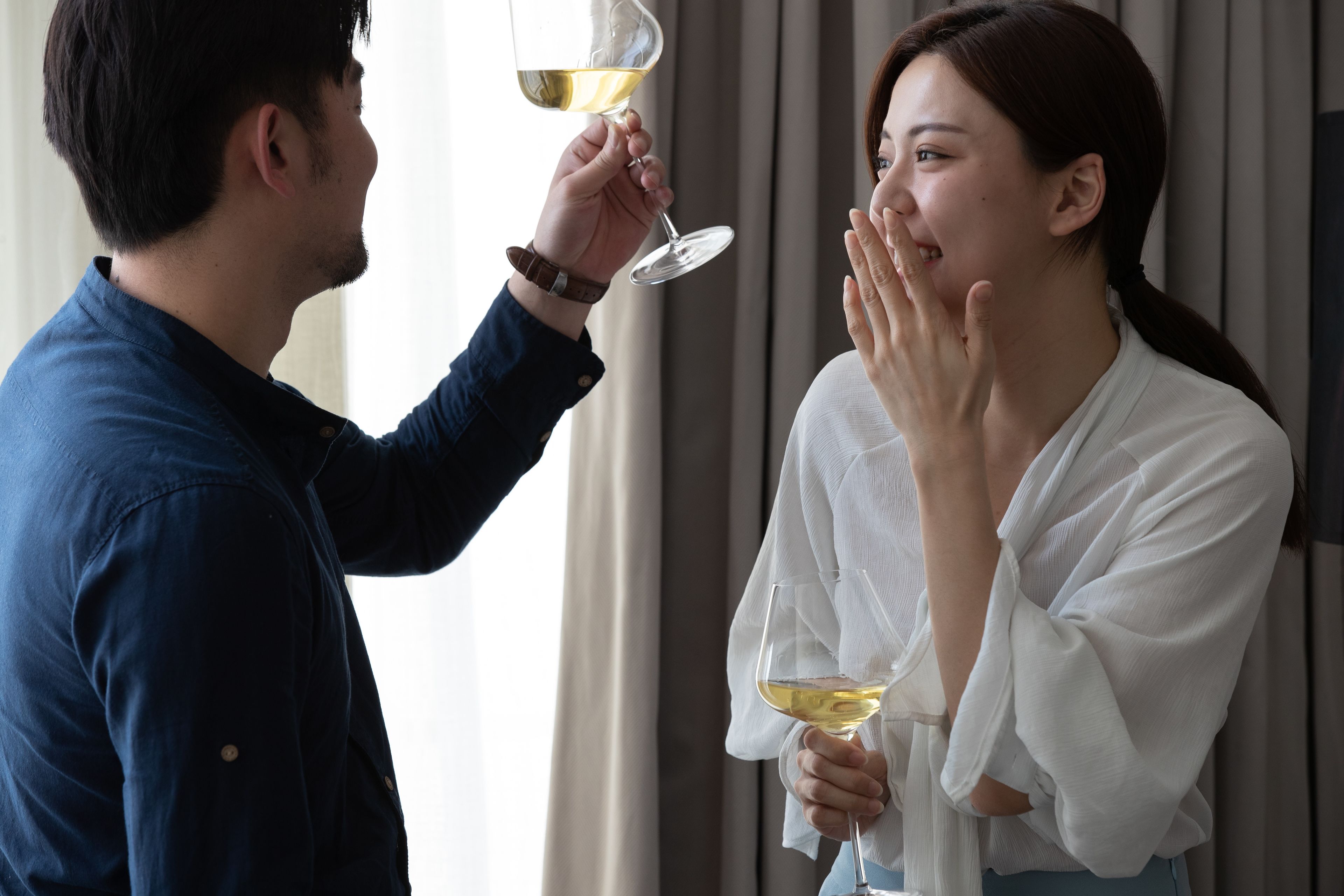 A man and a woman holding wine glasses.
