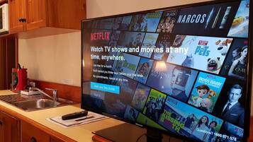 A television displaying a Netflix interface with various shows and movies.