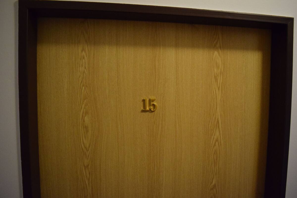 A wooden door with the number 15 on it.