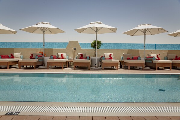 Outdoor pool, open 6:30 AM to 10 PM, pool umbrellas