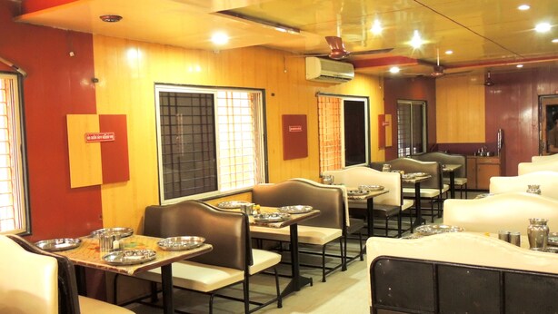 A restaurant with booths and tables, some with metal plates. - Hotel Greenpark (Danta)