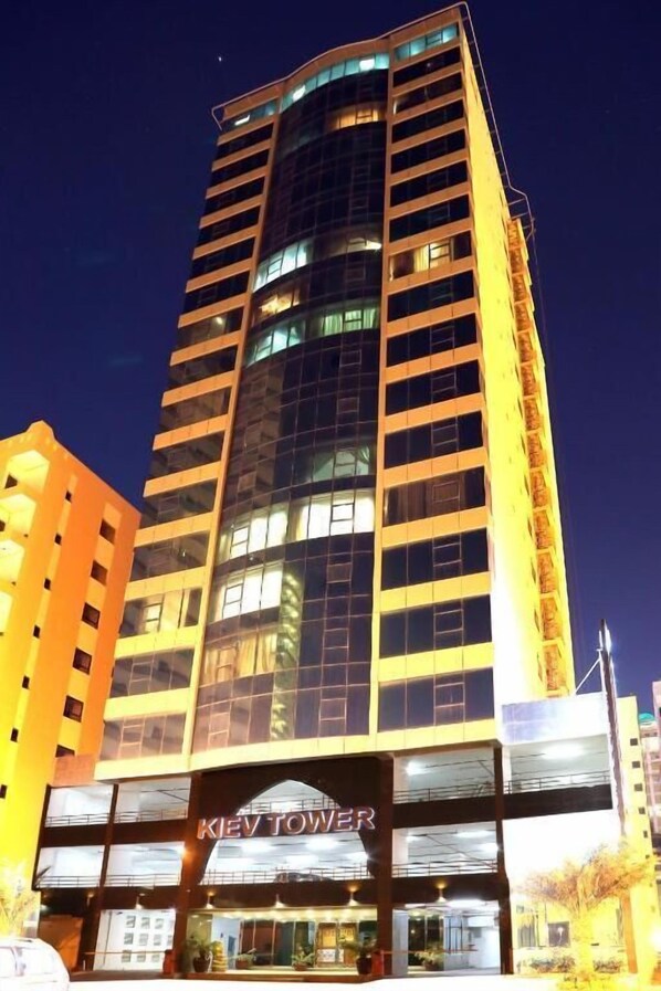 A tall hotel building with a prominent "KEV TOWER" sign at the entrance. - Kiev Tower Hotel Apartments (Manama)