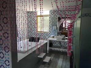 A modern bathroom with a white sink, a mirror, and a window. - Dreamhouse Theme Hotel (Shanghai)