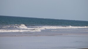 A beach with waves approaching the shore.