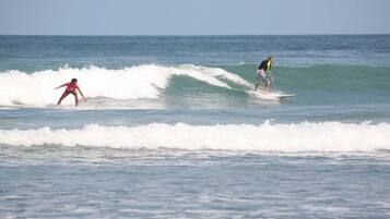 Two surfers on a wave in the ocean.