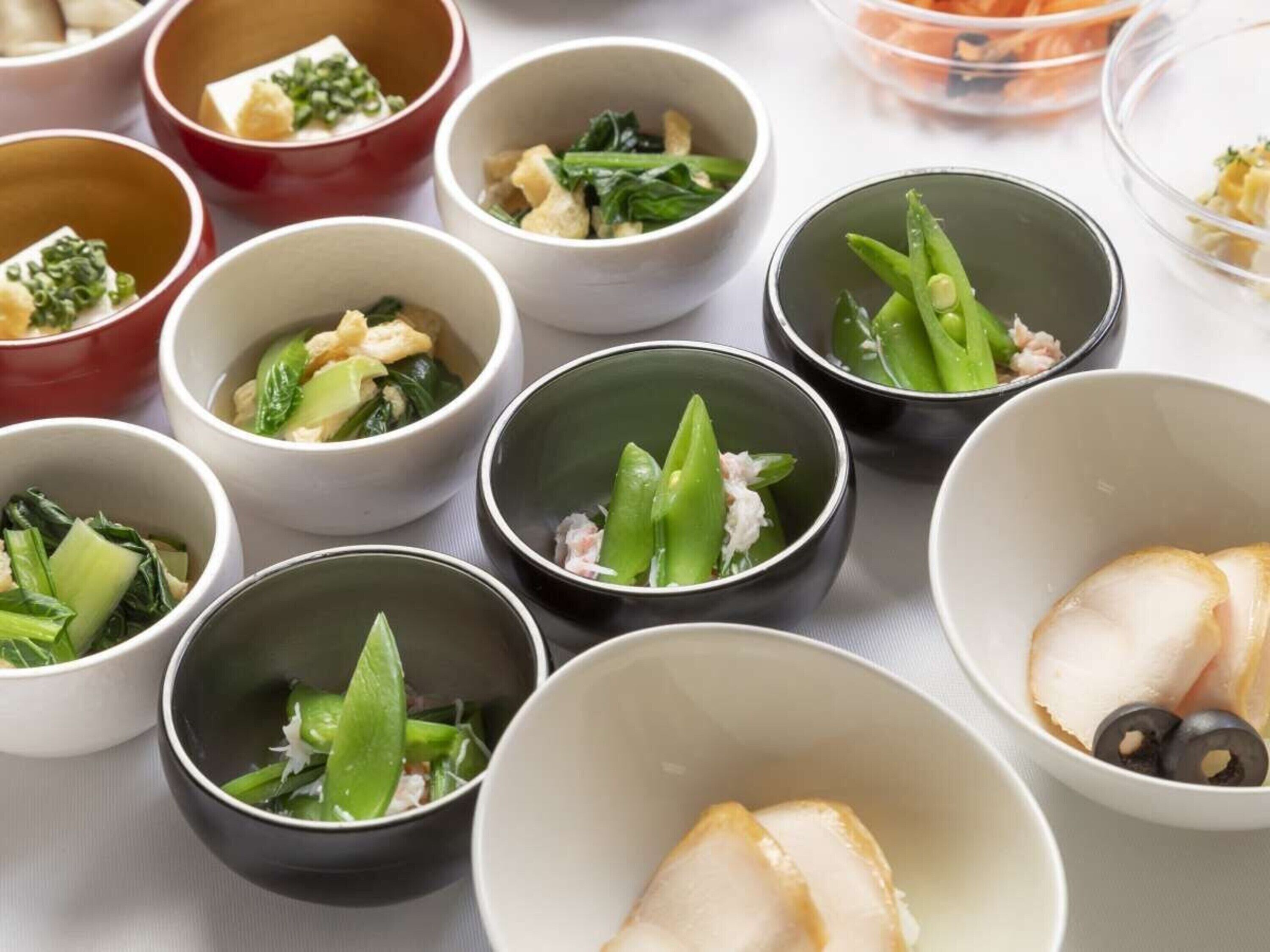 A variety of bowls containing different food items, likely part of a meal or buffet setup.