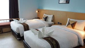 A hotel room with two beds, each with white linens and decorative pillows. - Samui City Hotel (Koh Samui)