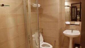 A bathroom with a glass-enclosed shower, a white sink, and a mirror above the sink. - My Inn Hotel Lahad Datu, Sabah (LAHAD DATU)