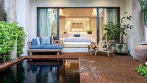 A bedroom with a bed, a sofa, and a small pool. - Raya Heritage (Mae Rim)