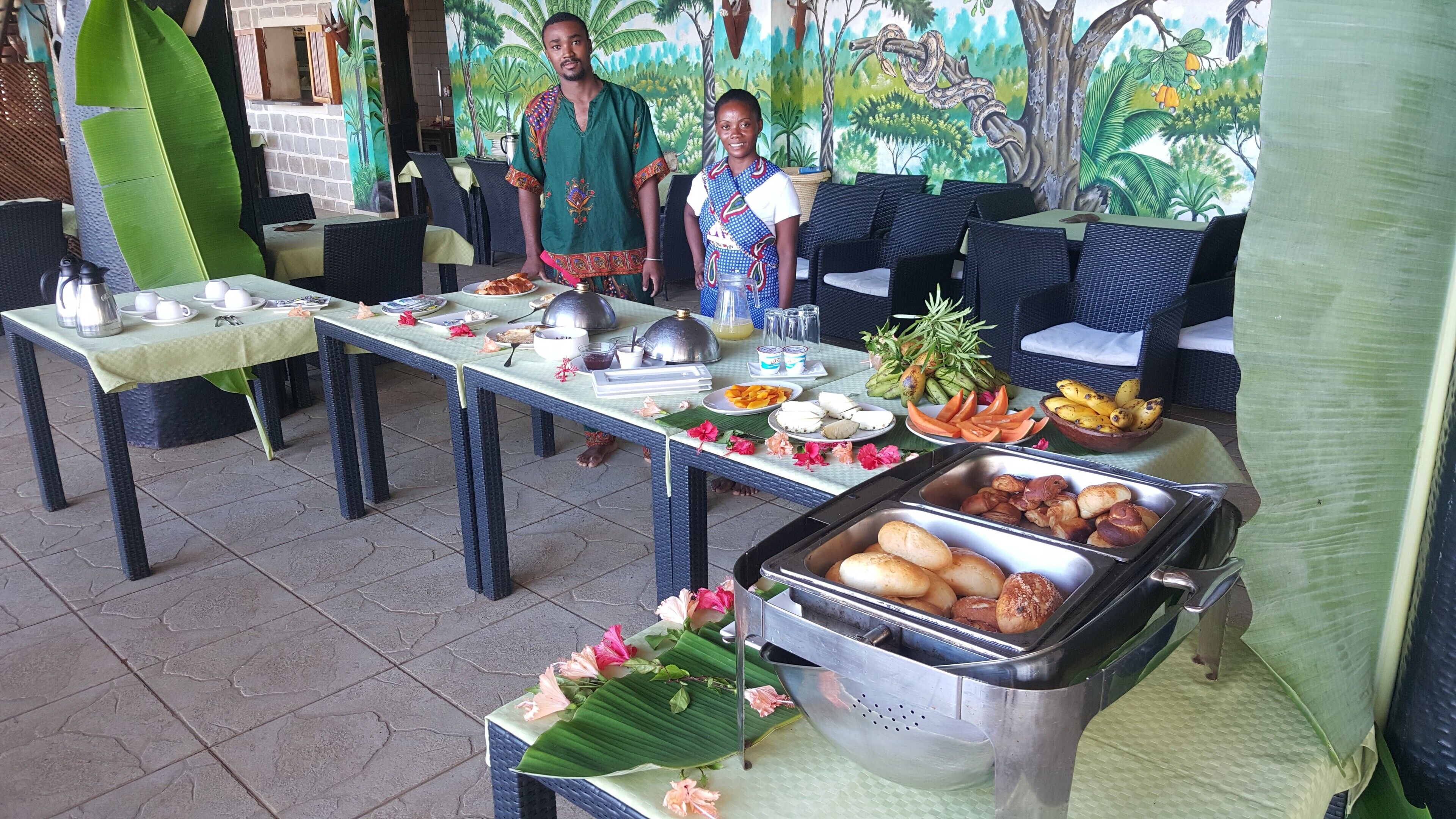 A buffet setup with various food items and a decorative table centerpiece.