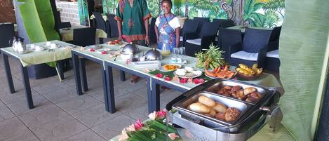 A buffet setup with various food items and a decorative table centerpiece.