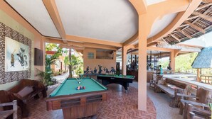 A pool area with a billiards table, seating, and a bar. - Punta Riviera Resort Bolinao (Bolinao)