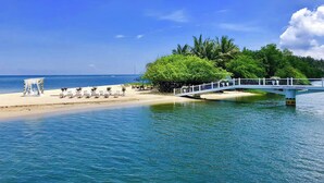 A beach with a white bridge, a white gazebo, and a white fence. - Punta Riviera Resort Bolinao (Bolinao)