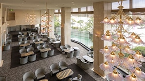 A spacious lobby with multiple seating areas, a large chandelier, and a view of the outdoors. - Awara Onsen Seifuso (Awara)