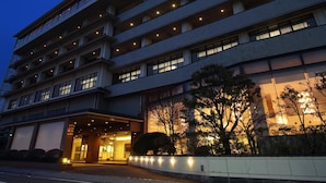 A multi-story hotel with a modern design, featuring a prominent entrance with a covered area and a landscaped garden. - Awara Onsen Seifuso (Awara)